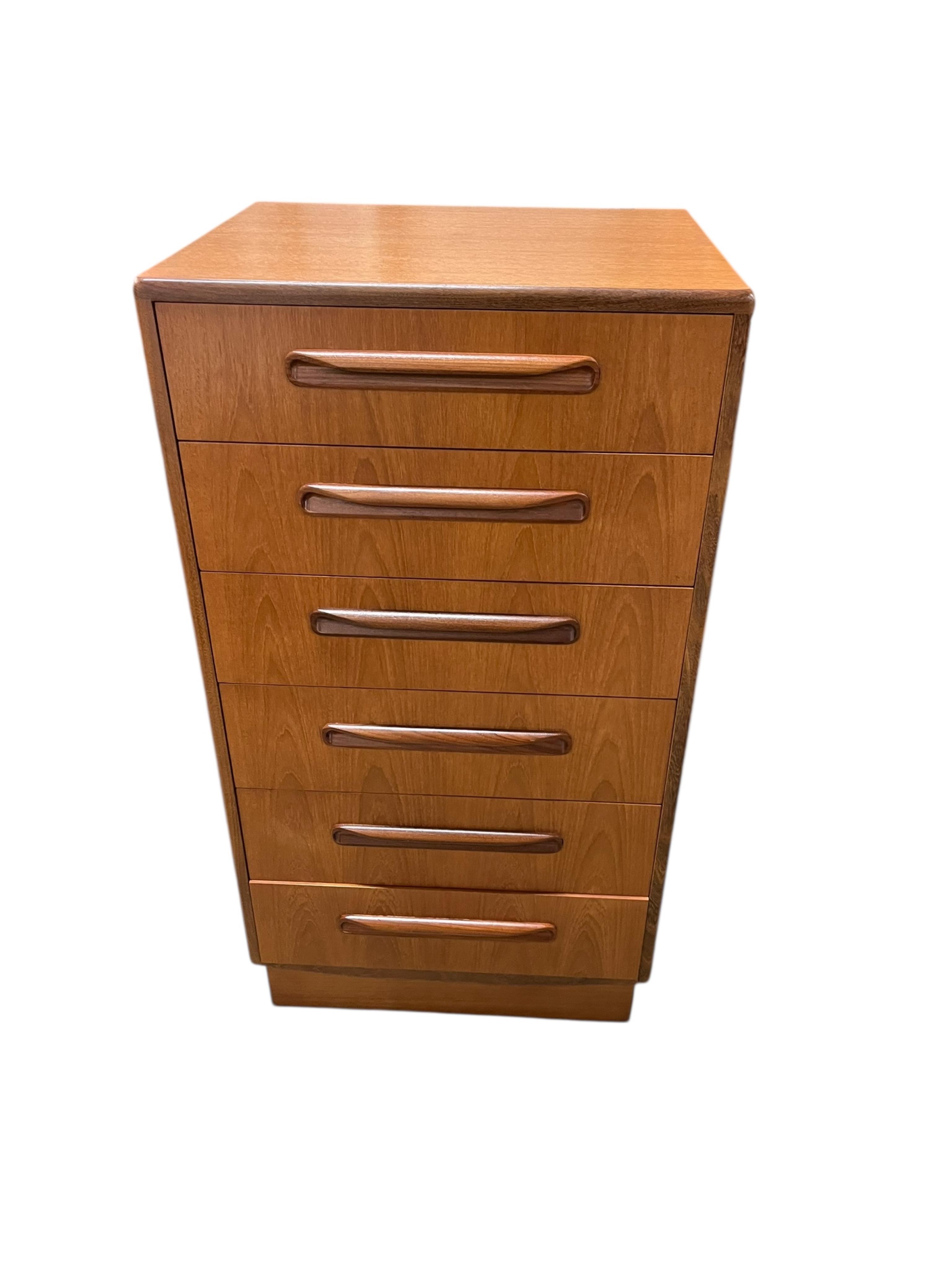 A mid century G Plan Fresco teak bedroom suite comprising a three door wardrobe, a two door wardrobe, two six drawer chests, dressing table, headboard and a pair of bedside chests